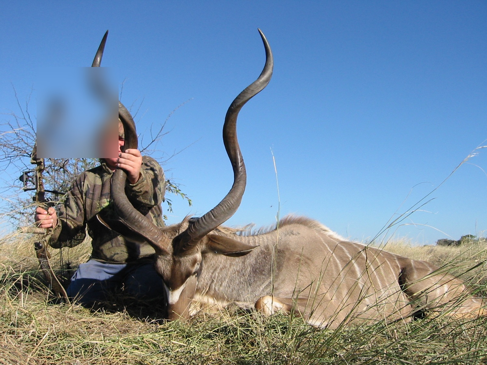 Greater kudu bull with bowhunter at Marula Game with face blurred for privacy