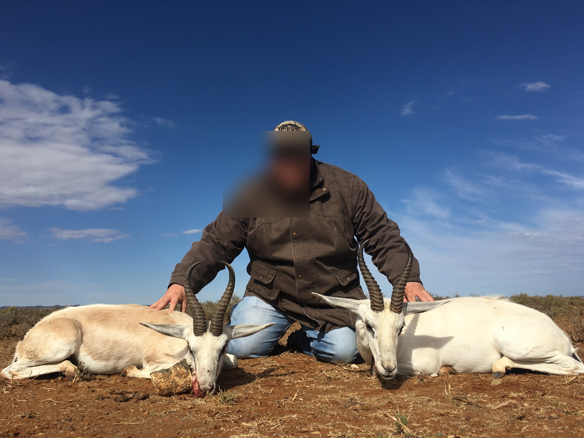 White springbok trophies with hunter at Marula Game with face blurred for privacy